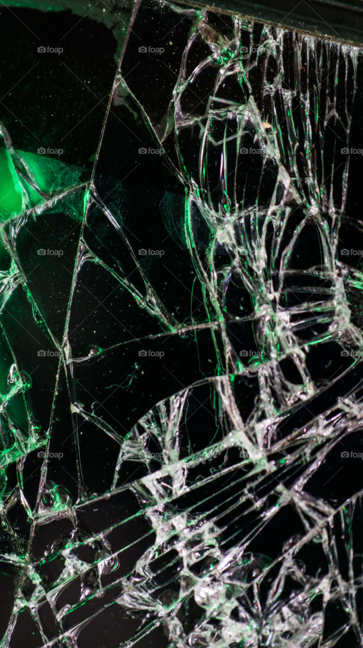 Multi-colored and bright broken smartphone screen close-up.