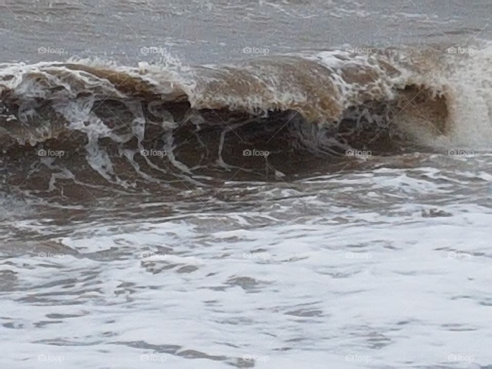 curling of the wave at cleveleys beach crashing down over and over.