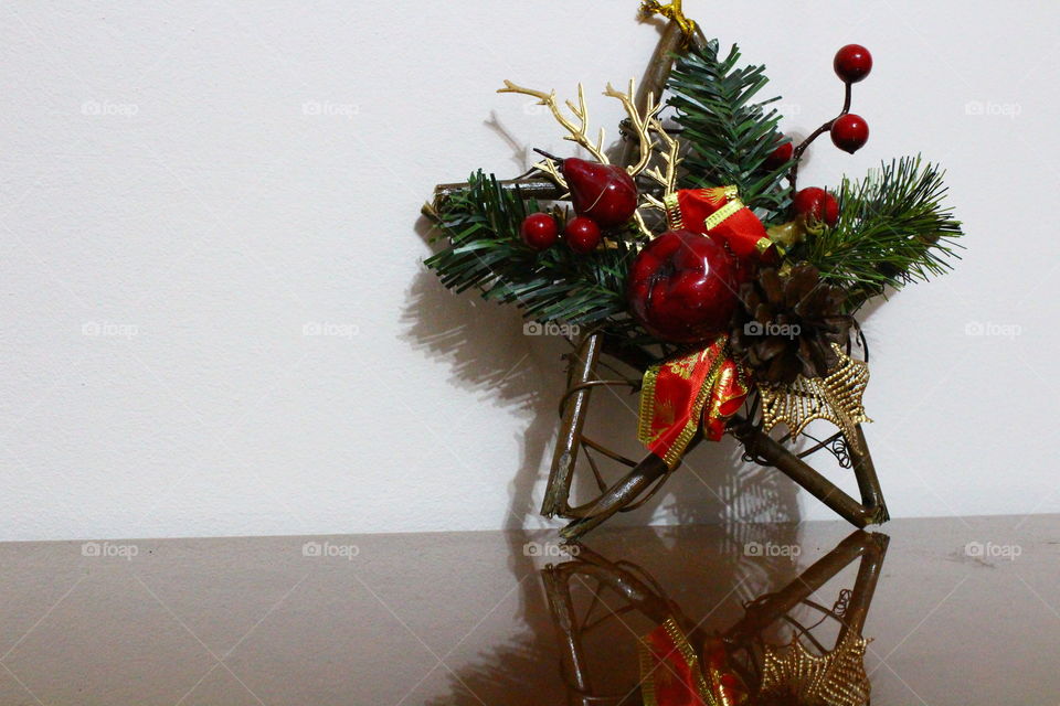 Christmas wooden star with decorations on a wooden table