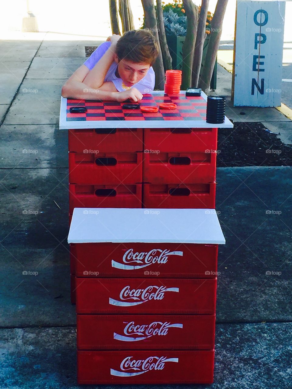 Sidewalk game of checkers with Coka Cola