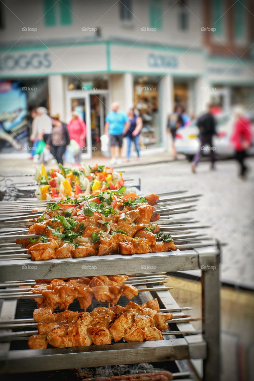 Skewered kebabs being sold as street food in a street market.