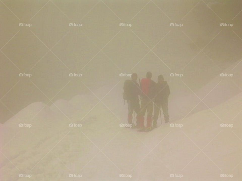 Three hikers in the fog, Alpes, France
