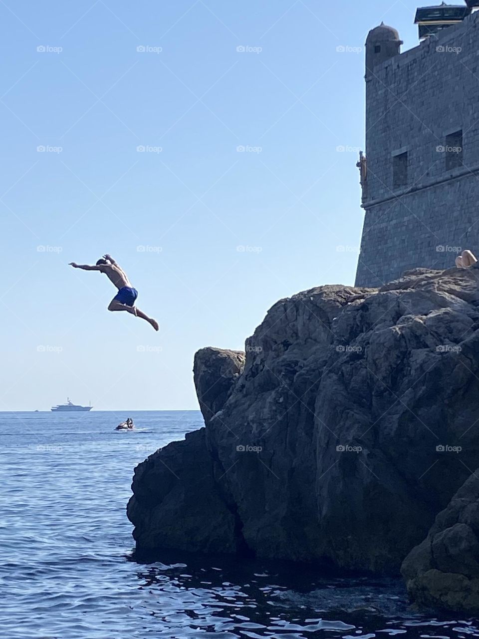 The joys of a hot summer day and jumping from the rocks into the cool sea with the walls of Dubrovnik looming in the background.