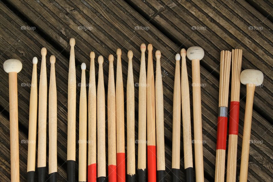 Various drumsticks on a wooden background 