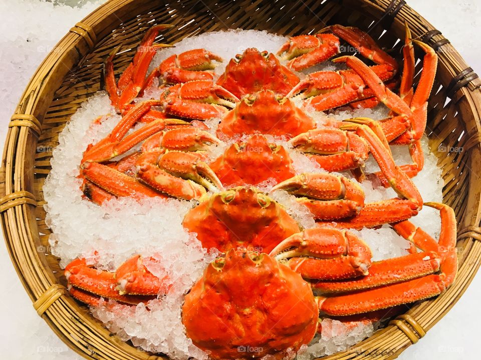 Fresh king crab in the basket with ice seafood gourmet cuisine at fish market in Taipei, Taiwan