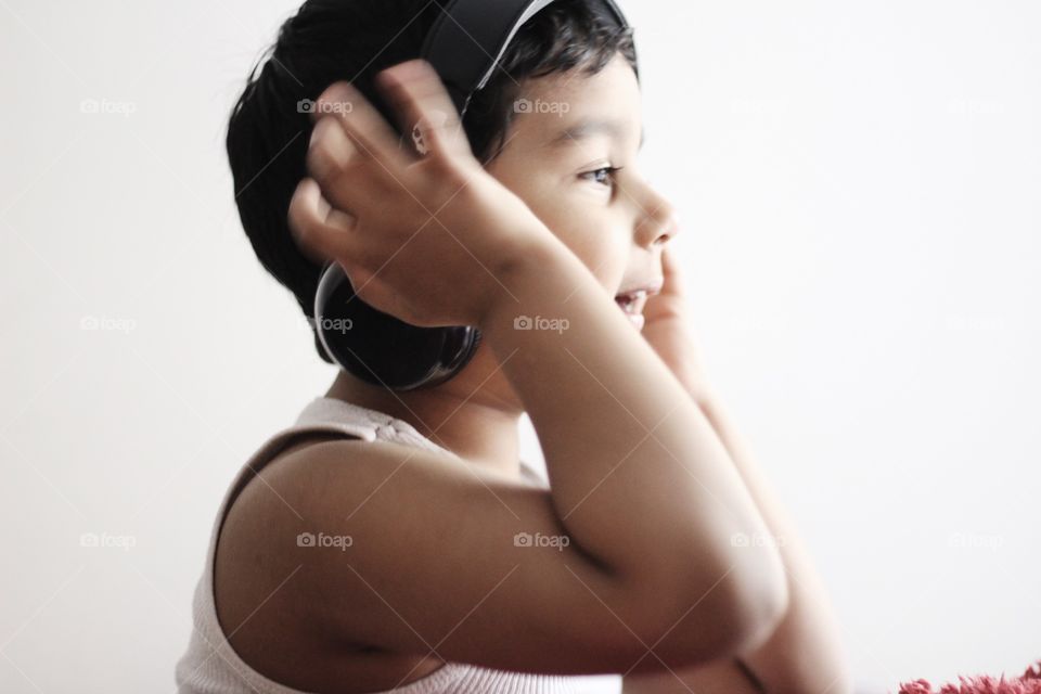 Kid having Fun listening music in headphone 🎧 