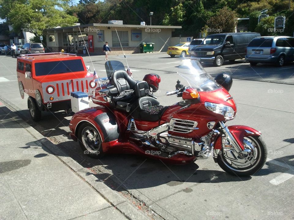 Stunning motorbike with a blazing red paint job shining in the summer sun