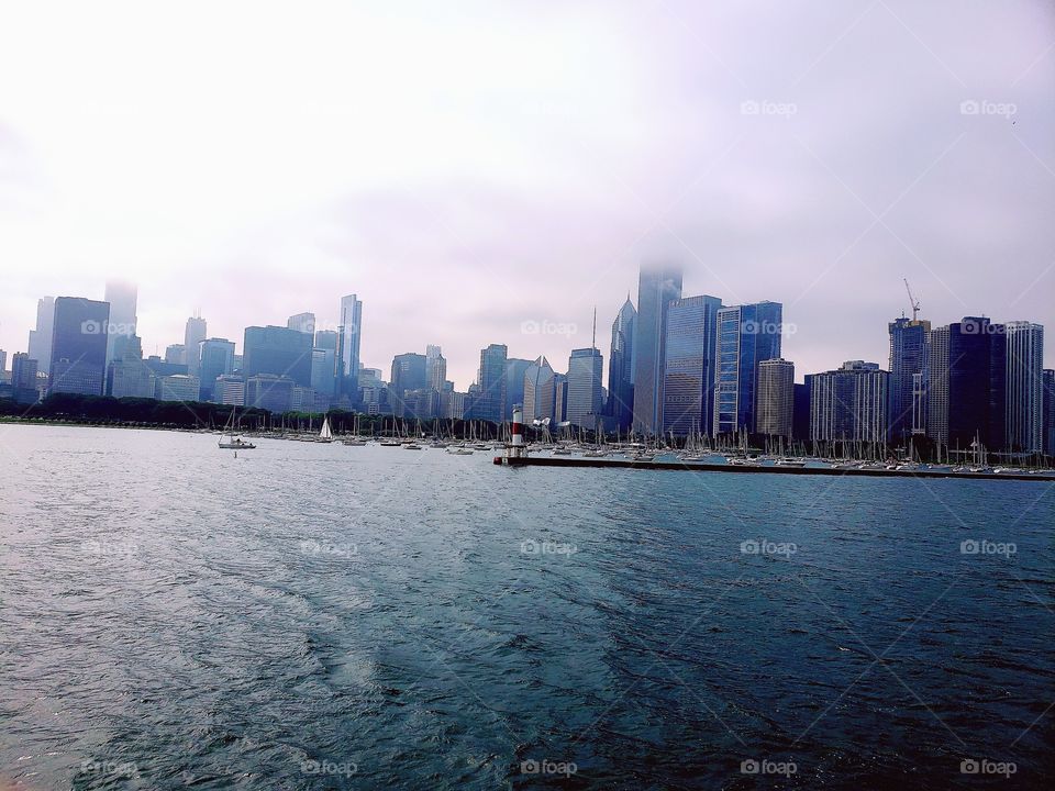 View of foggy downtown Chicago and Navy Pier from Lake Michigan