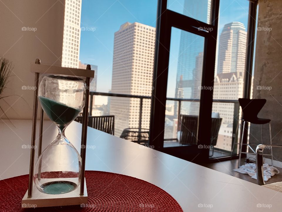 Hourglass on a desk in a high rise apartment. Los Angeles, California 