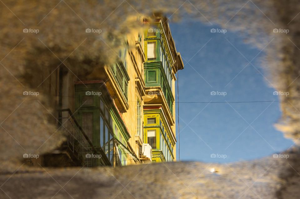 Street reflections in a water puddle