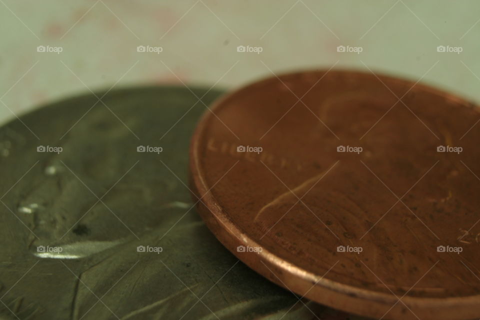 macro photography of a penny and nickel