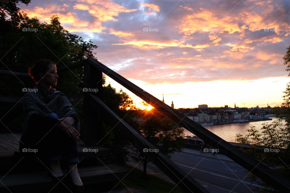 Sitting woman in the sunshine . Stockholm Sweden 