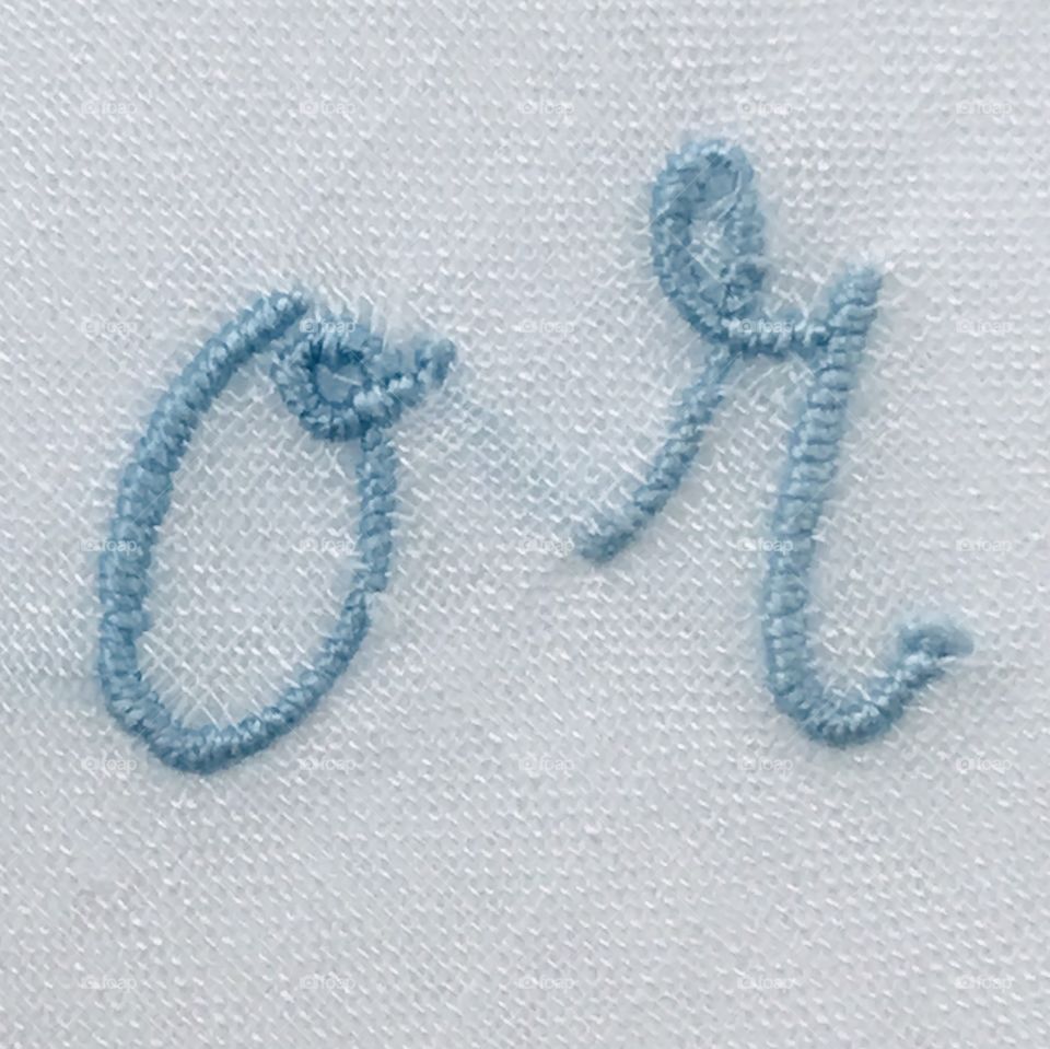 Blue embroidered lowercase letters o r word or with white background