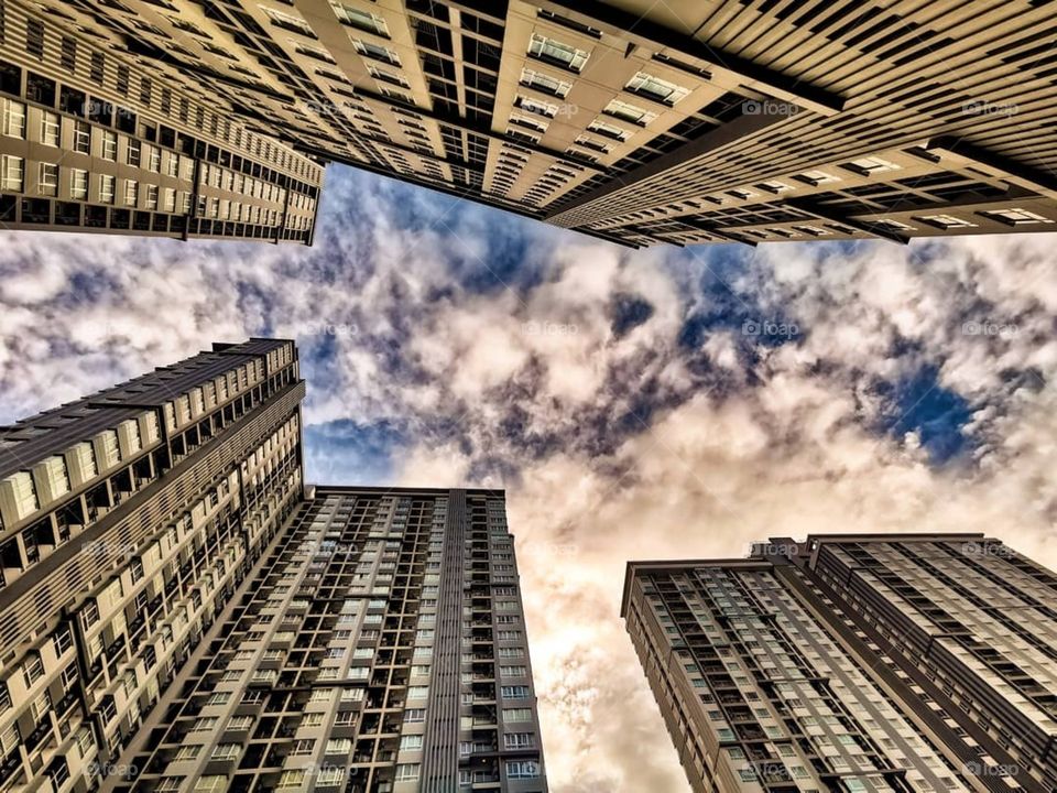 Looking straight up at a surreal sky between the three buildings of my condo complex in Bangkok, Thailand.