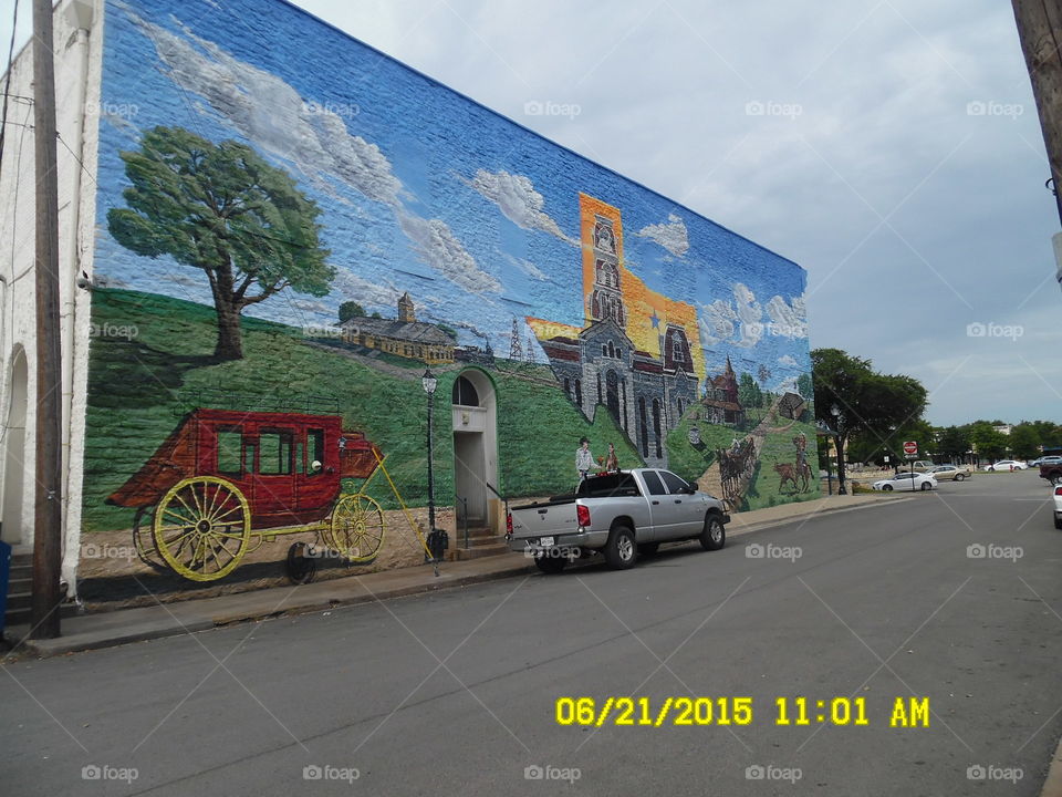Texas size Muriel. this is a picture of the old west painted on the side of this building