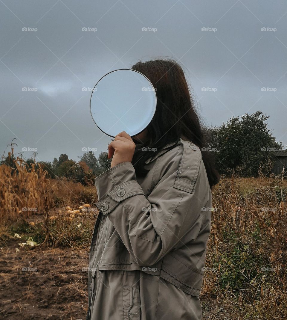 Portrait of a girl with a mirror