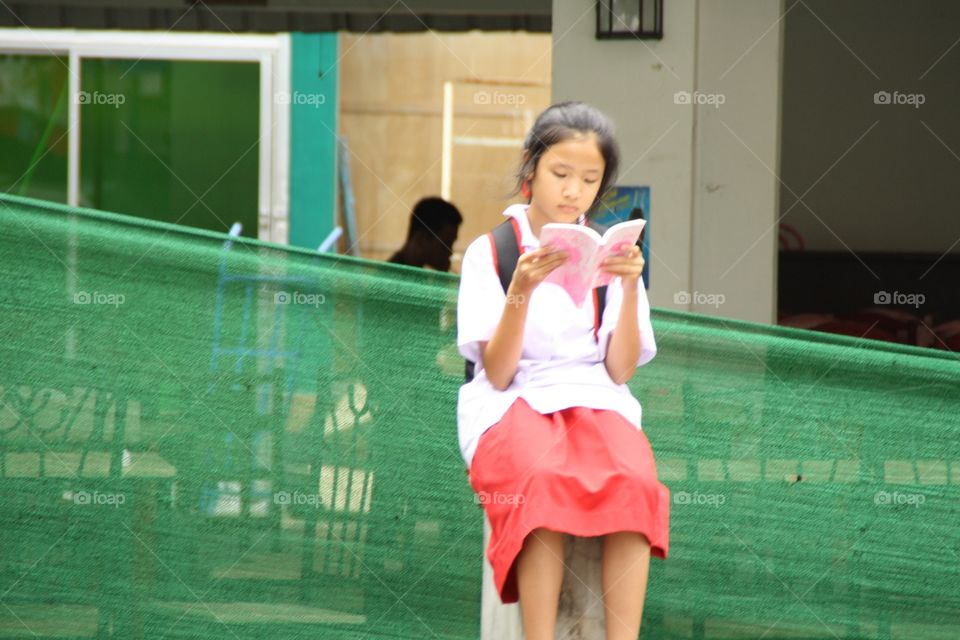Young girl reading. This girl was reading while waiting