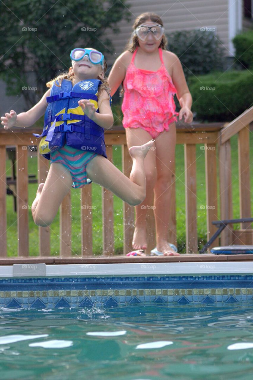 Girl jumping in pool