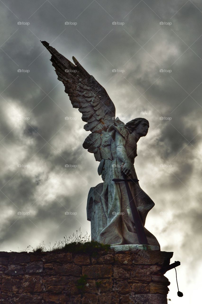 Statue of the Angel of Death at the Modernist cemetery in Comillas, Cantabria, Spain.