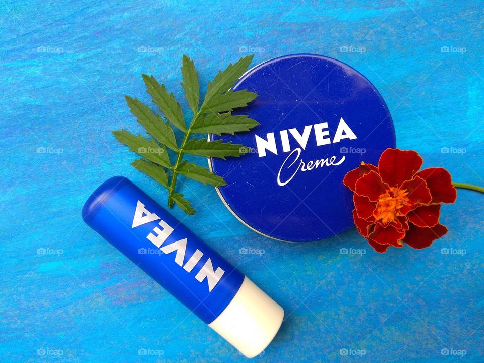 Nivea cream and lipstick summer time blue background, love products
