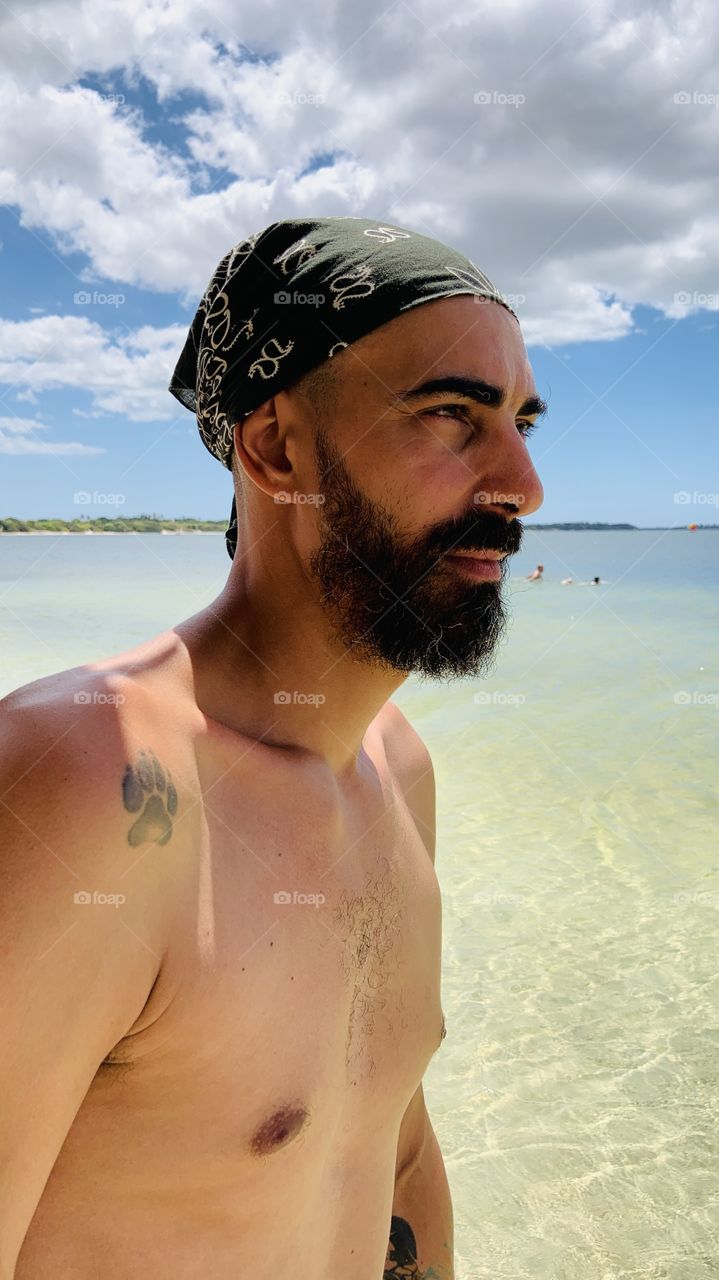 Man with beard  against lake