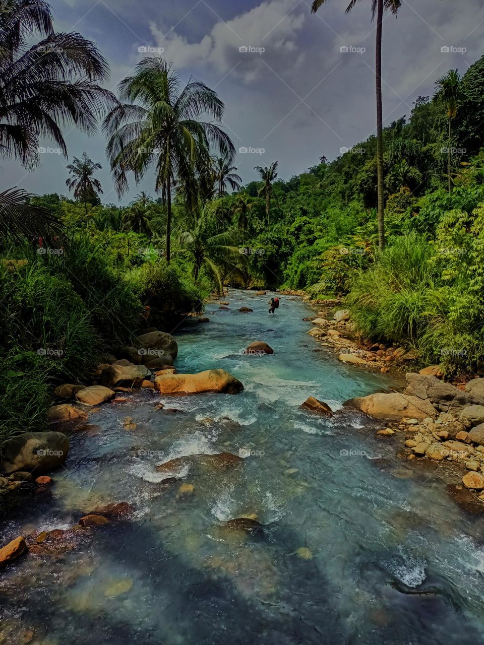 Panoramic landscape of bright blue river of dua rasa river and tropical rain forest