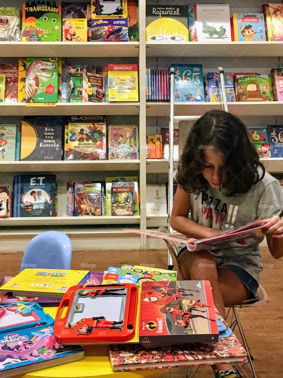 Child reading a book in the library