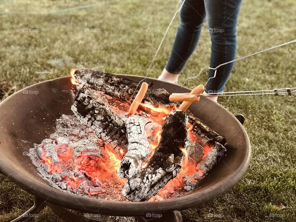 Roasting hotdogs is a traditional thing that Americans do in any season. 