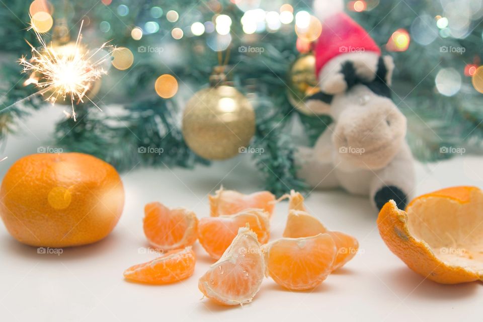 card with tangerine slices and Christmas toys on the background