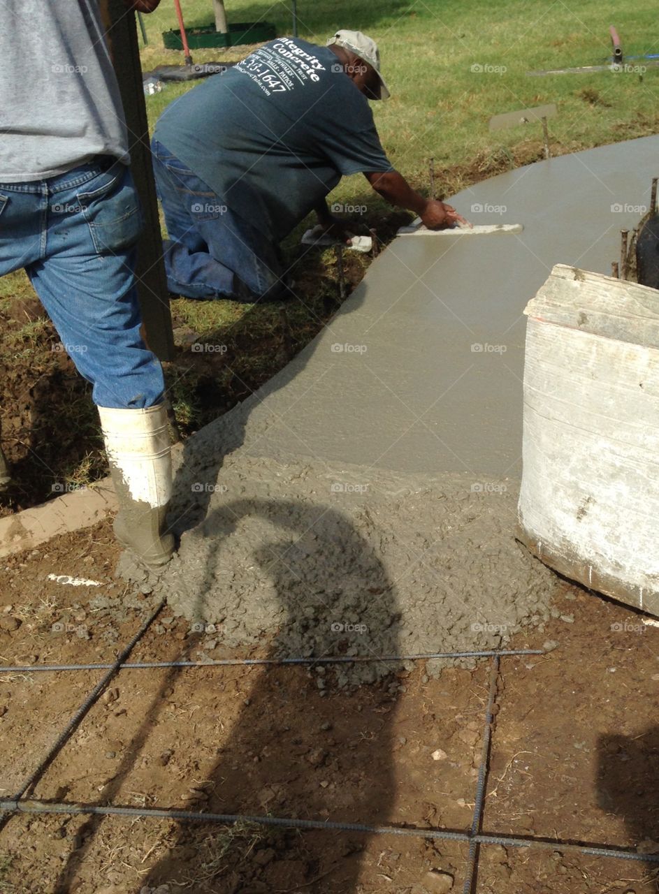 Men creating a sidewalk