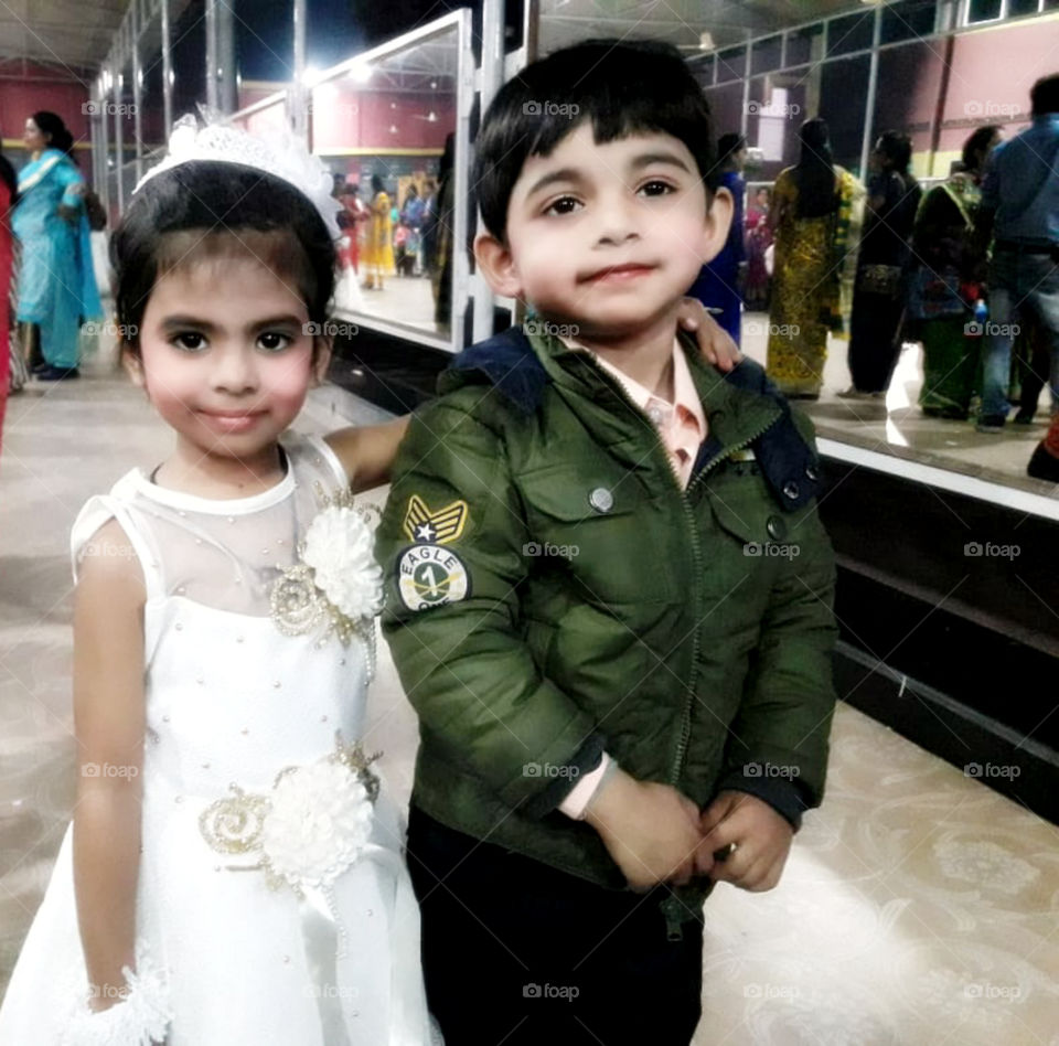 Baby girl looking happy with her friend.