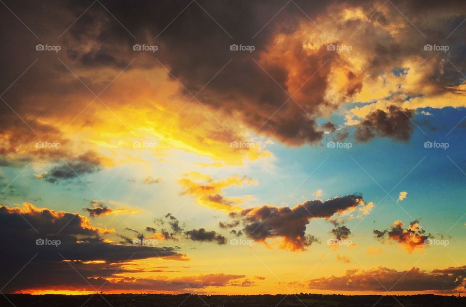 Cloudy sky over landscape during sunset