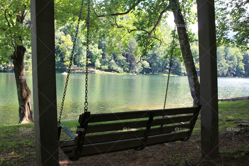 Empty swing near lake
