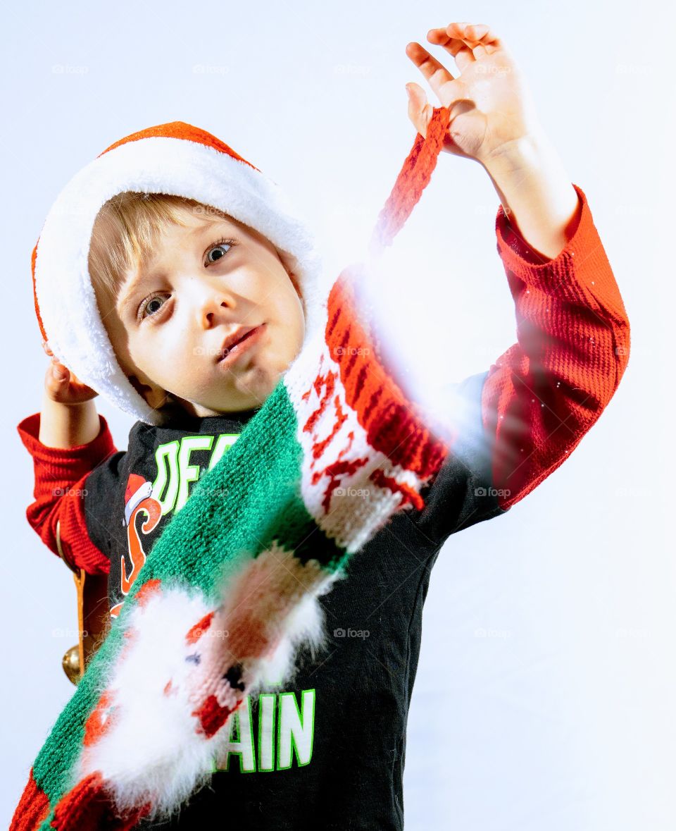 Toddler boy posing for fun Christmas photos