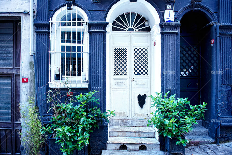 the old white door with black heart pattern