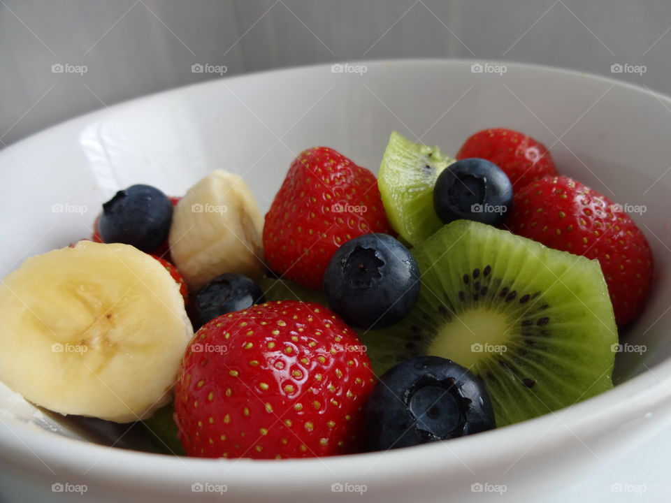 Healthy fruits breakfast full of vitamins with strawberry, kiwi, banana and berries