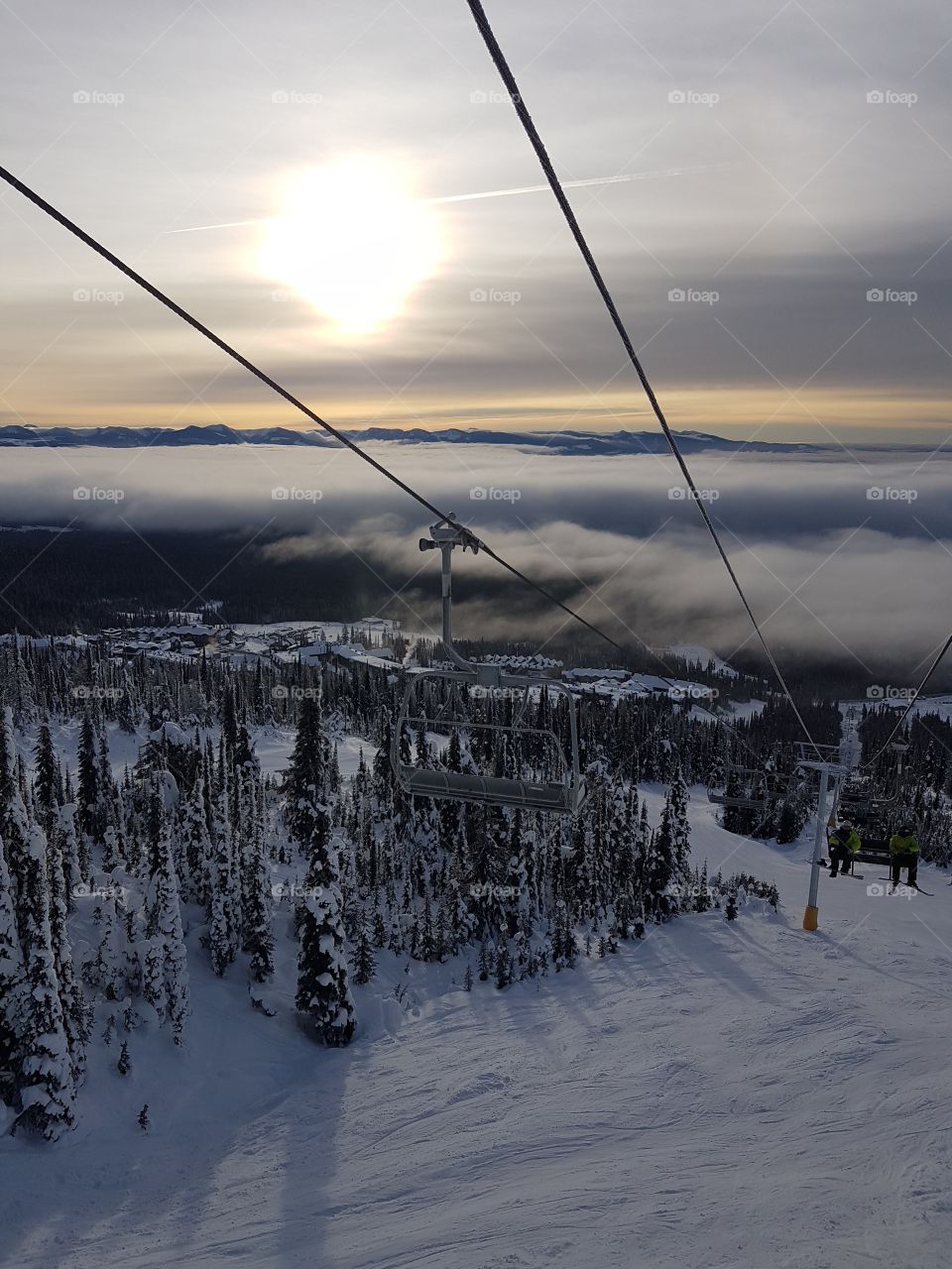 View from the chair lift with town and inverted cloud layer in the valley