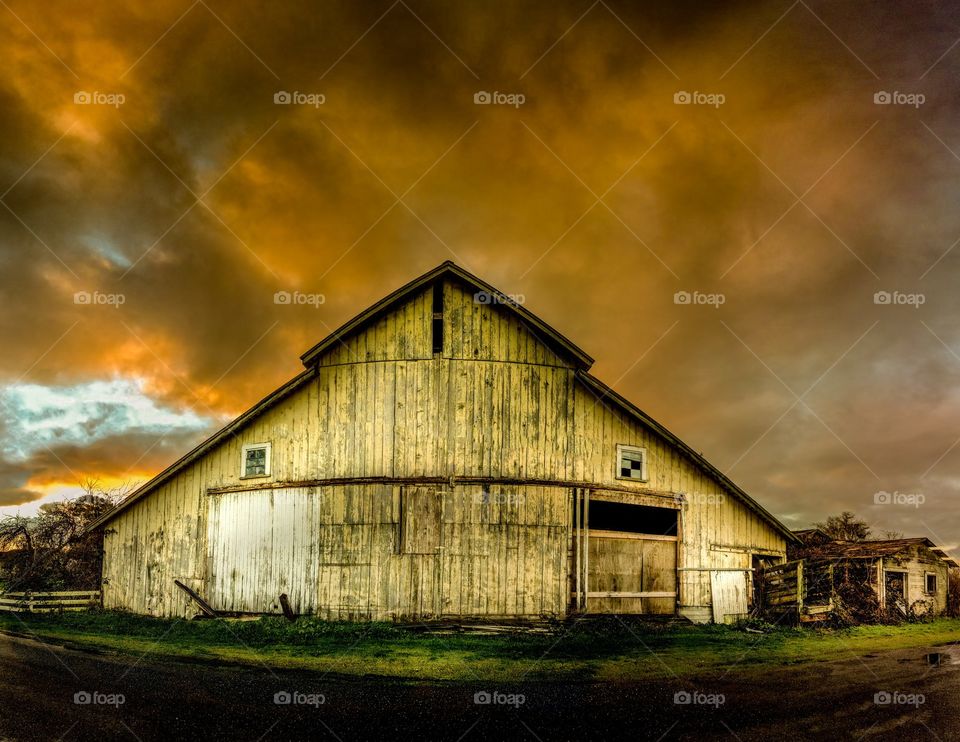 Old wooden barn against cloudy sky