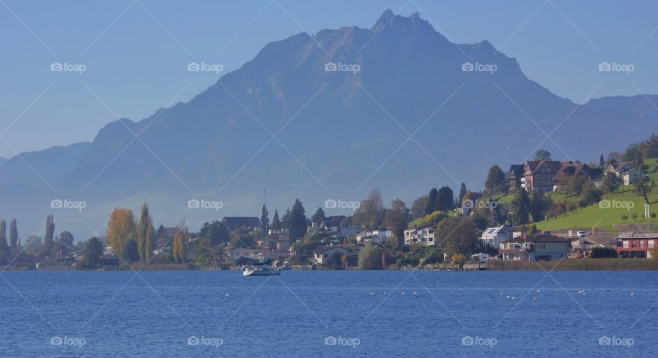 Scenic view of house and lake against sky