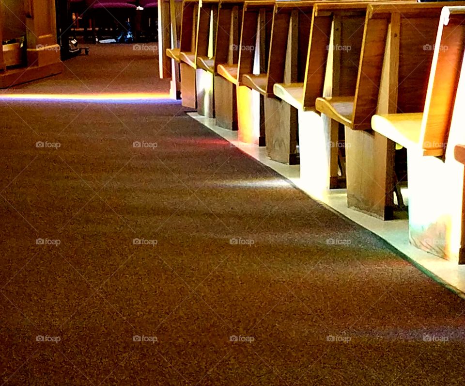 sun shining through the stained glass windows at a church