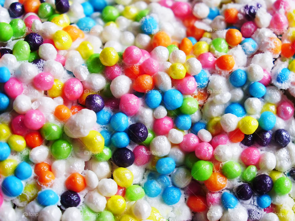 Bright background made of Colorful round sugar sprinkles 