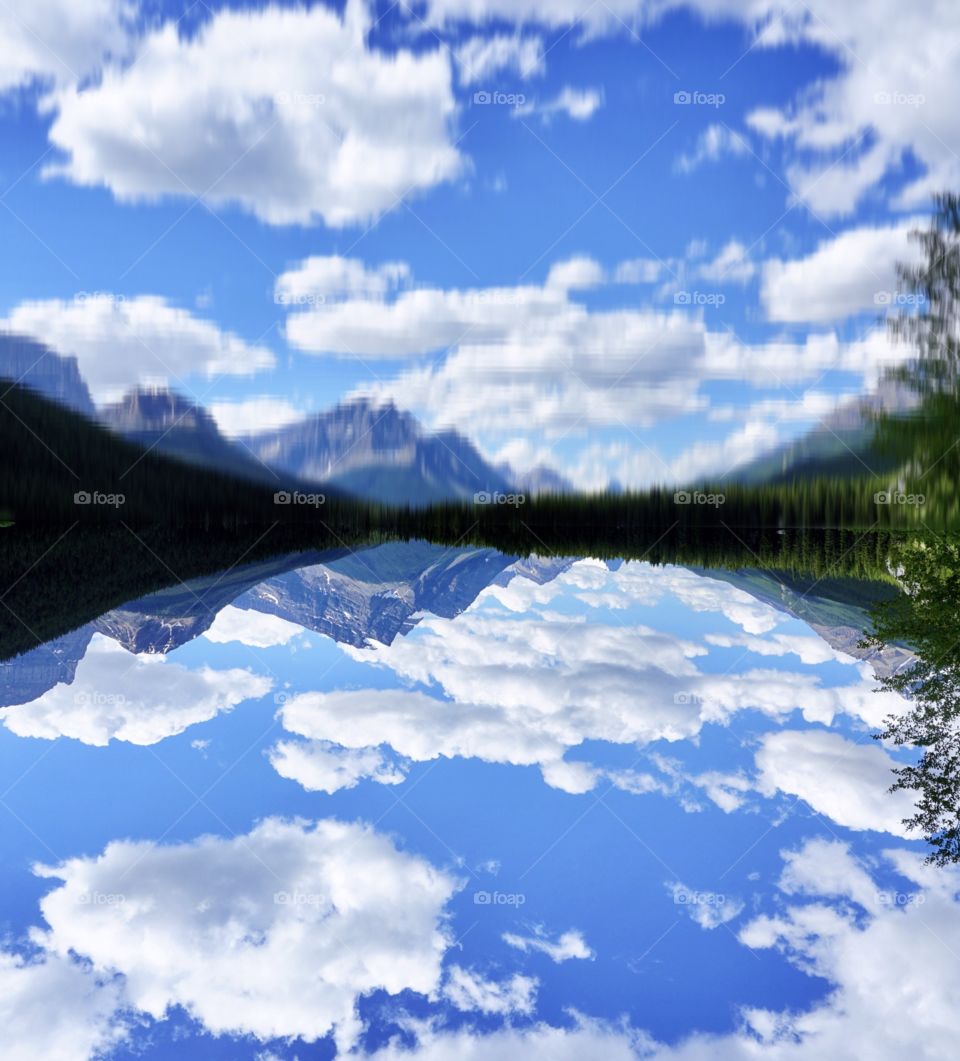 Canadian Clouds floating in  a blue sky reflected in a beautiful 🇨🇦 Lake 