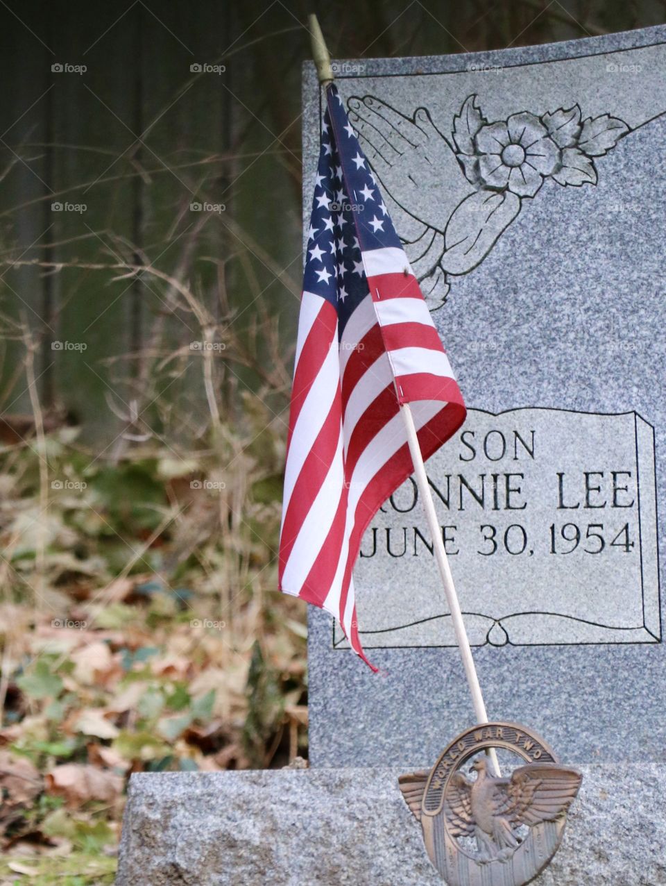 American Flag beside a tombstone 