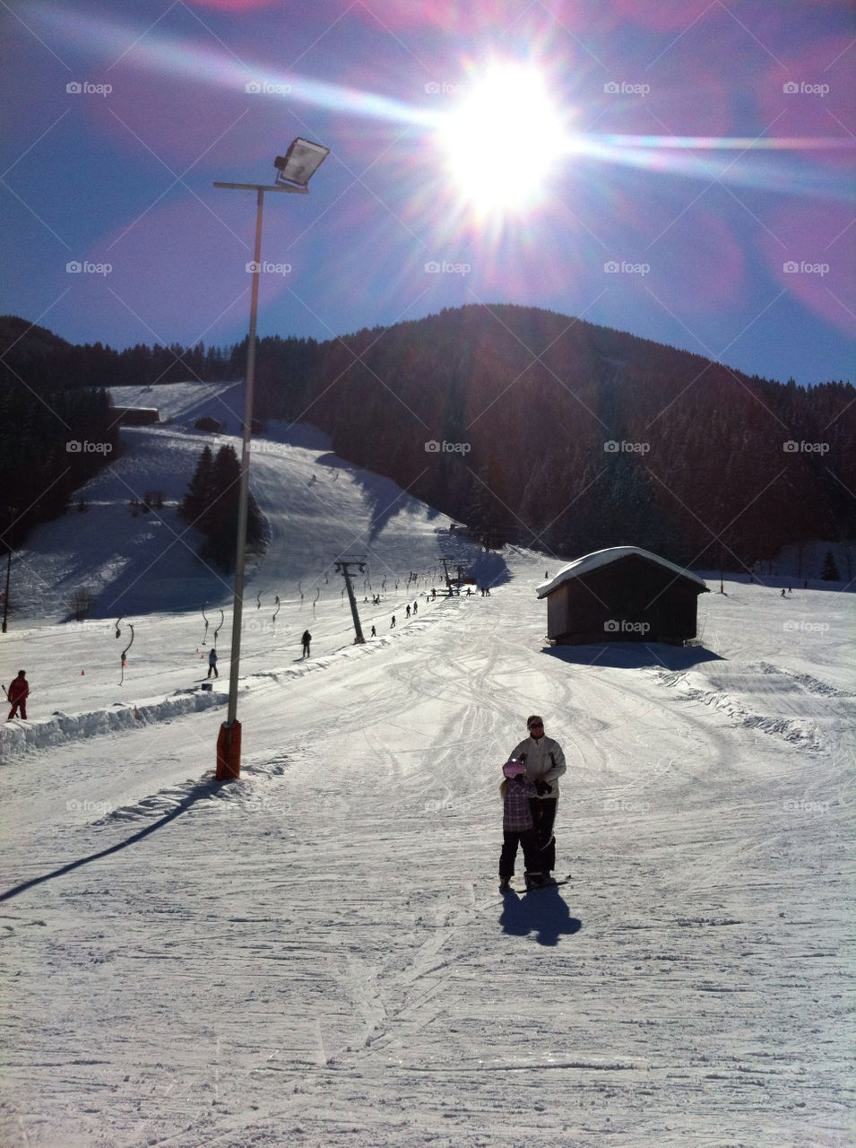snow sun mountains skiing by latzara