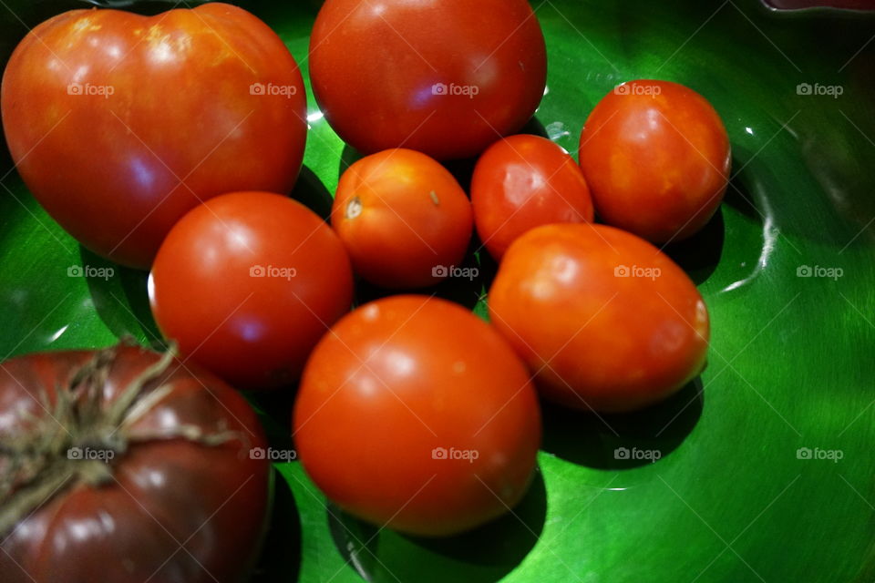 Tomatoes on a green plate