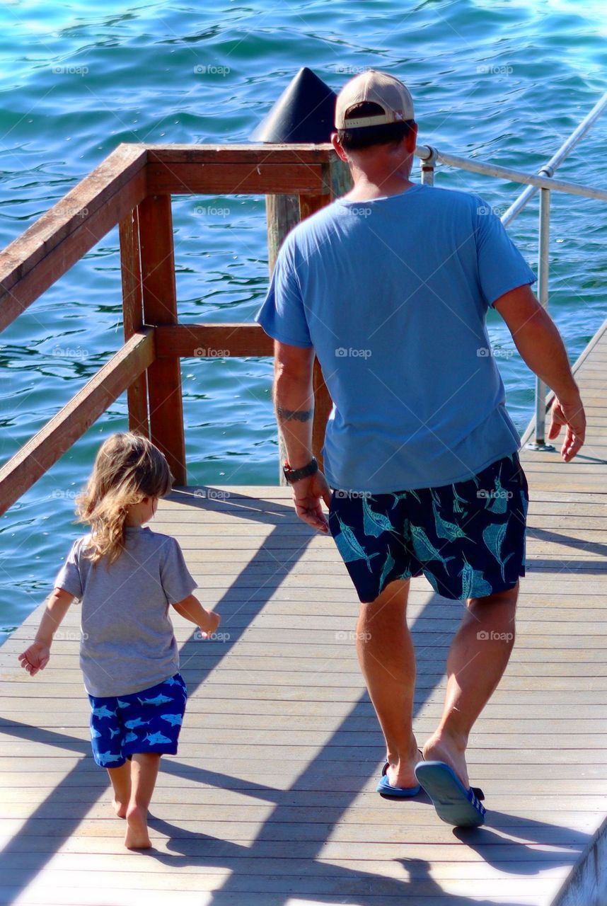 A man and his grandson match in blue while enjoying a day at the lake in Washington 