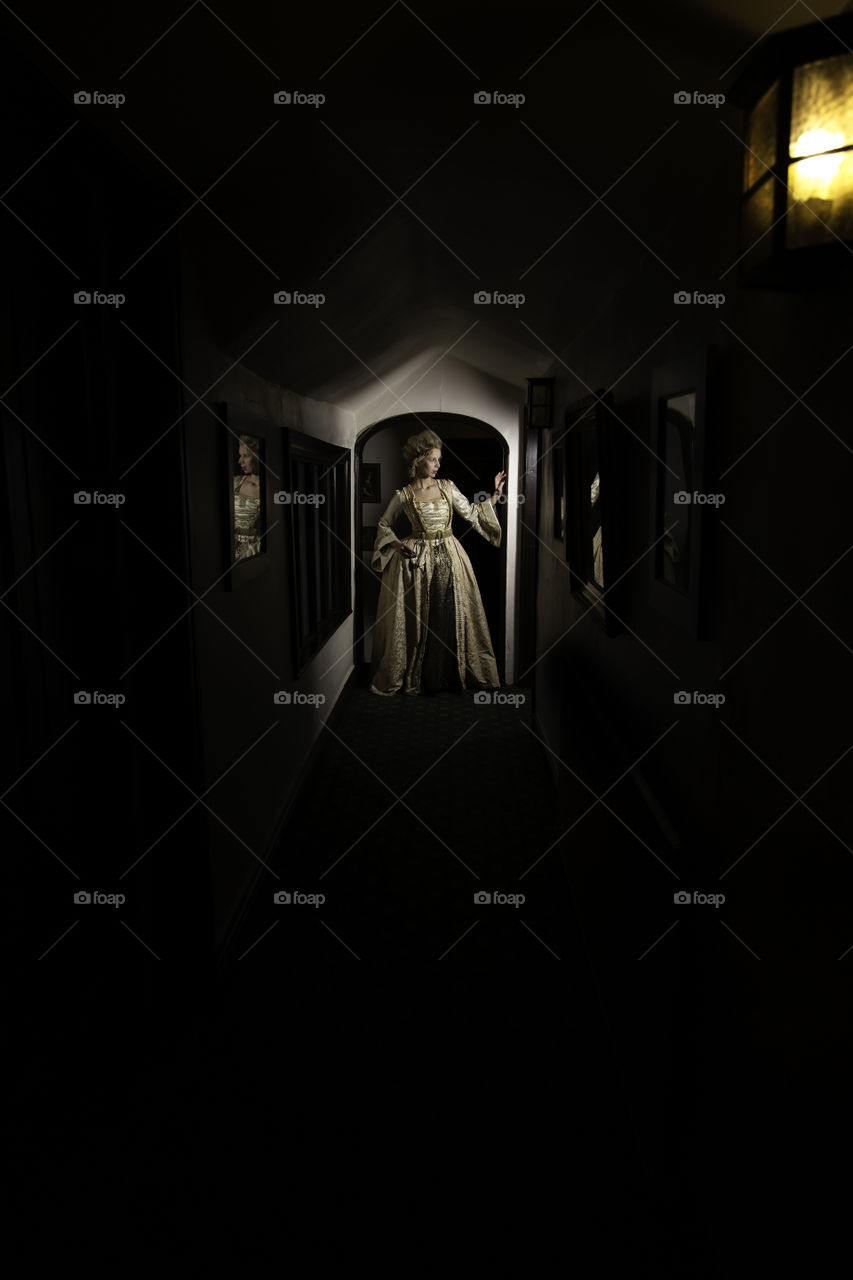 One of a set of photos taken in a 17th century house that is now a restaurant and hotel. The look is based around Marie Antoinette with long luxurious dress and hair styled high. Makeup was very pale and finished using baby powder