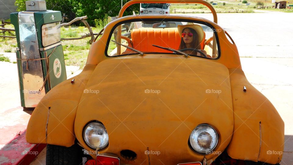 A woman on a nice car
This car look like a cartoon vehicle