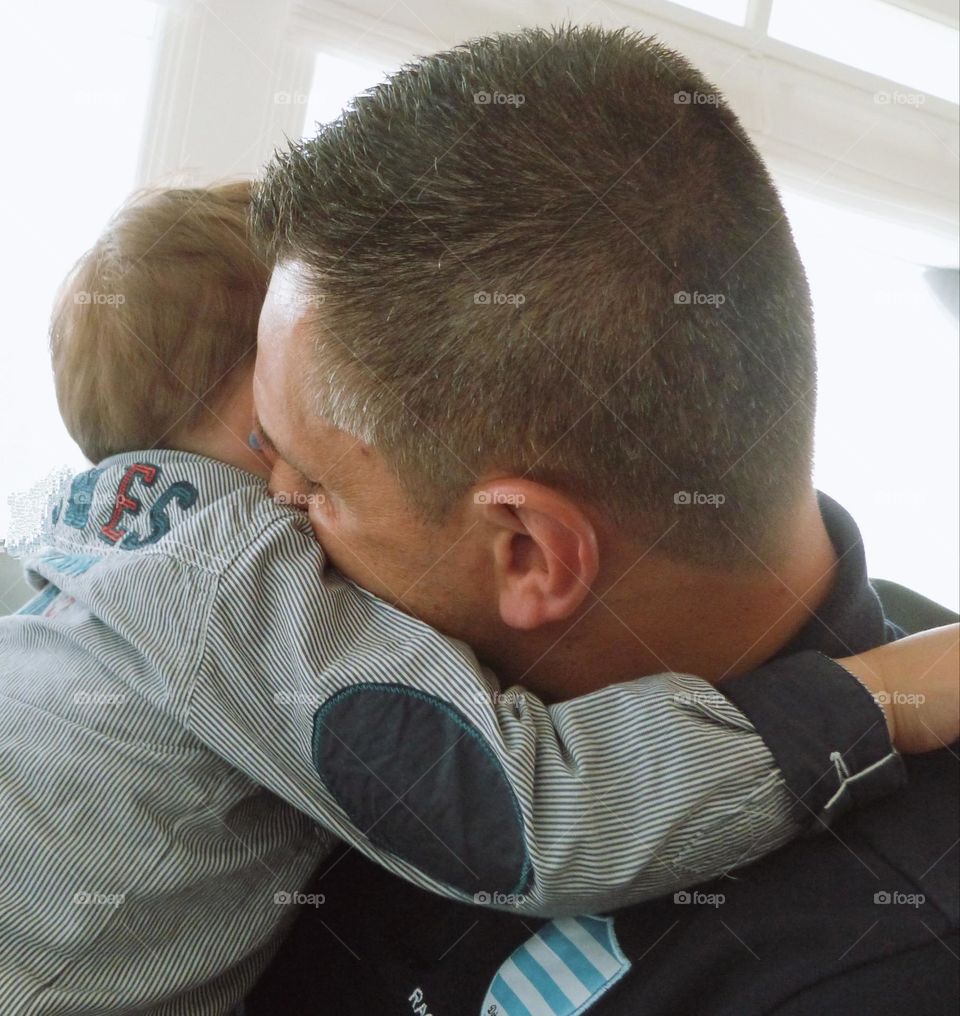 A lot of tenderness emerges from this hug between a dad and his little boy