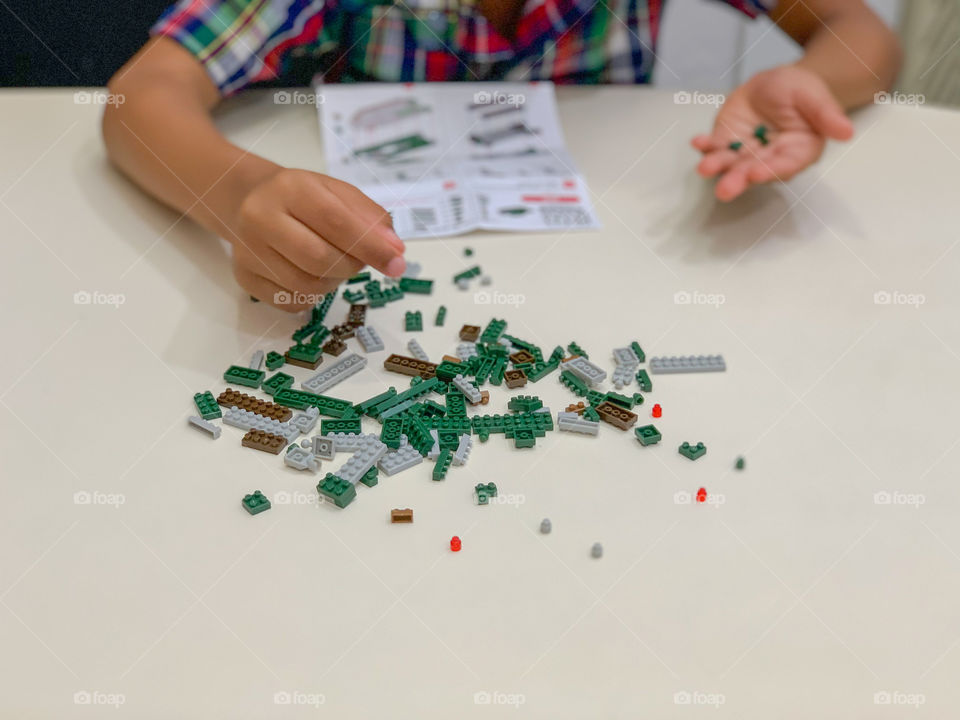 Child playing with construction toy 